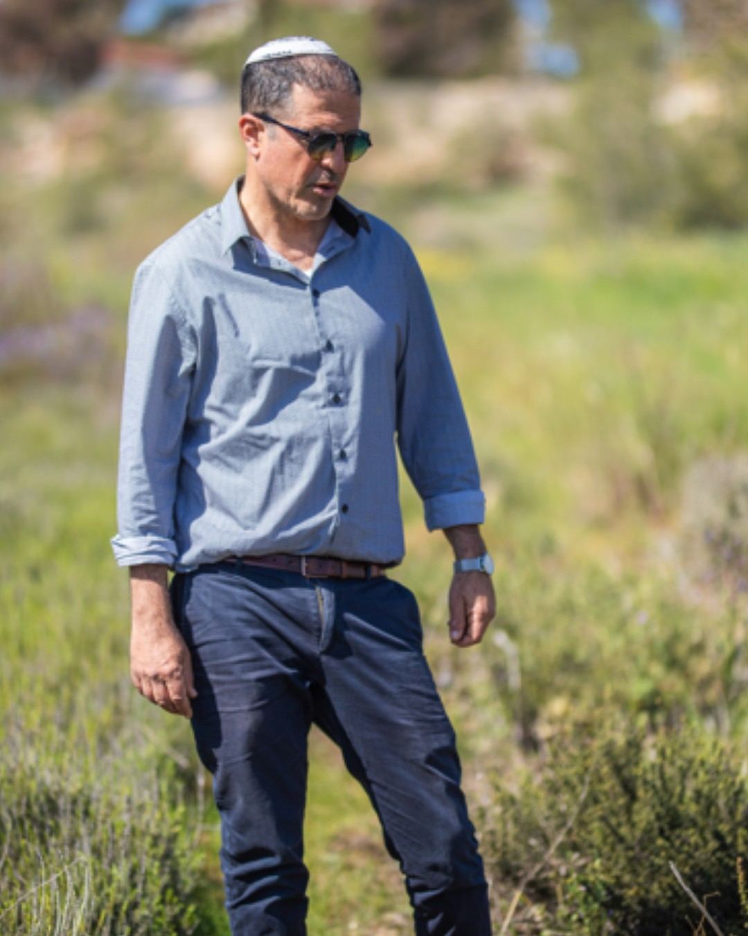 Dr. Amir Kitron walking through a study field